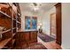Home office with built-in bookcases and hardwood floors at 26615 N 71St Pl, Scottsdale, AZ 85266