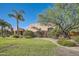 Landscaped front yard with a long driveway leading to a two-story house at 26615 N 71St Pl, Scottsdale, AZ 85266