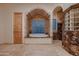 Relaxing bathroom with soaking tub, glass block window, and marble finishes at 26615 N 71St Pl, Scottsdale, AZ 85266