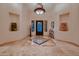 Grand entryway with tiled floors and an ornate chandelier at 26615 N 71St Pl, Scottsdale, AZ 85266