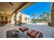 Spacious backyard oasis with a pool, patio furniture, and lush landscaping at 26615 N 71St Pl, Scottsdale, AZ 85266