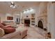Spacious living area with a fireplace and built-in shelving at 26615 N 71St Pl, Scottsdale, AZ 85266