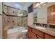 Clean bathroom with a bathtub, shower, and granite countertop at 26615 N 71St Pl, Scottsdale, AZ 85266
