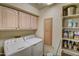 Convenient laundry room with washer, dryer, and storage shelves at 8870 E Greenview Dr, Gold Canyon, AZ 85118