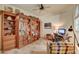 Home office with custom wooden built-ins and comfortable seating at 8870 E Greenview Dr, Gold Canyon, AZ 85118