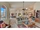 Bright living room with high ceilings, tiled floors, and comfortable seating at 8870 E Greenview Dr, Gold Canyon, AZ 85118