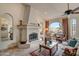 Living room with a fireplace and views of the desert at 8870 E Greenview Dr, Gold Canyon, AZ 85118