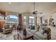 Spacious living room with mountain views, comfortable seating, and a fireplace at 8870 E Greenview Dr, Gold Canyon, AZ 85118