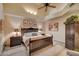 Main bedroom with high ceiling, dark wood furniture, and ceiling fan at 8870 E Greenview Dr, Gold Canyon, AZ 85118