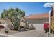 House exterior with lush landscaping and a garage at 8870 E Greenview Dr, Gold Canyon, AZ 85118