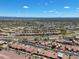 Aerial view showcasing a community of homes, pool, and surrounding area at 8870 E Greenview Dr, Gold Canyon, AZ 85118