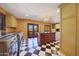 Bright laundry room with custom cabinetry, checkerboard floor, and a workspace at 6107 E Paradise Dr, Scottsdale, AZ 85254