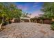View of the courtyard and the home's double wood garage doors at 6107 E Paradise Dr, Scottsdale, AZ 85254
