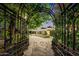 Ornate iron gate entrance to a courtyard with fountain at 6107 E Paradise Dr, Scottsdale, AZ 85254