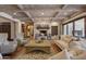 Living area with a cozy fireplace and high wood-beamed ceilings at 6107 E Paradise Dr, Scottsdale, AZ 85254