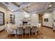 Elegant dining room with stone fireplace and rustic wooden beams at 6107 E Paradise Dr, Scottsdale, AZ 85254