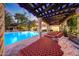 Relaxing poolside lounge area with pergola and comfortable seating at 6107 E Paradise Dr, Scottsdale, AZ 85254