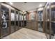 Spacious walk-in closet with glass-front cabinetry and wood flooring at 6107 E Paradise Dr, Scottsdale, AZ 85254