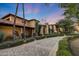 Luxury home exterior with stone accents and palm trees at 6107 E Paradise Dr, Scottsdale, AZ 85254