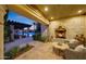 Relaxing patio with fireplace and seating area overlooking the pool at 6107 E Paradise Dr, Scottsdale, AZ 85254