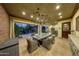 Covered patio features a large dining table and comfortable wicker chairs at 6107 E Paradise Dr, Scottsdale, AZ 85254
