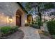 Elegant entryway with double doors, stonework, and pathway lighting at 6107 E Paradise Dr, Scottsdale, AZ 85254