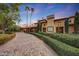 Tuscan-style home with a stone driveway and manicured landscaping at 6107 E Paradise Dr, Scottsdale, AZ 85254