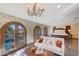 Luxurious bedroom with a king-size bed, sitting area, and French doors opening to a balcony at 6107 E Paradise Dr, Scottsdale, AZ 85254