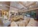 Gathering room with fireplace, high ceilings, and access to the pool area at 6107 E Paradise Dr, Scottsdale, AZ 85254