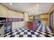 Large laundry room with island, granite countertops, and black and white floor at 6107 E Paradise Dr, Scottsdale, AZ 85254