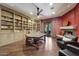 Home office with built-in bookshelves and fireplace at 6107 E Paradise Dr, Scottsdale, AZ 85254