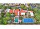 Aerial view of home showcasing pool, tennis court, and landscaping at 6107 E Paradise Dr, Scottsdale, AZ 85254