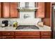 Modern gas cooktop with stylish range hood at 2440 E Saint Catherine Ave, Phoenix, AZ 85042