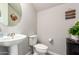 Clean and bright bathroom with pedestal sink and toilet at 2440 E Saint Catherine Ave, Phoenix, AZ 85042