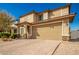 Two story home with tan exterior and two car garage at 2440 E Saint Catherine Ave, Phoenix, AZ 85042