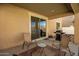Covered patio with seating and built-in grill at 2440 E Saint Catherine Ave, Phoenix, AZ 85042