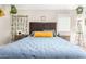 Well-lit bedroom with a queen bed and dark brown frame at 2440 E Saint Catherine Ave, Phoenix, AZ 85042