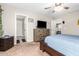 Primary bedroom with dresser, TV, and access to bathroom at 2440 E Saint Catherine Ave, Phoenix, AZ 85042