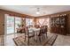 Bright dining room with pool view, table, chairs, and decorative rug at 18031 N Buntline Dr, Sun City West, AZ 85375