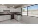 Updated kitchen with white cabinets, dark countertops, and tile floors at 8508 W Clarendon W Ave, Phoenix, AZ 85037