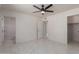 Spacious bedroom with tile floors, ceiling fan, and mirrored closet at 8508 W Clarendon W Ave, Phoenix, AZ 85037