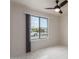 Bright bedroom with tile floors, ceiling fan, and view of the street at 8508 W Clarendon W Ave, Phoenix, AZ 85037