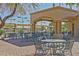 Community patio with tables and chairs under covered area at 15016 W Monterey Way, Goodyear, AZ 85395