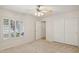 Bright bedroom with ceiling fan and double door closet at 15016 W Monterey Way, Goodyear, AZ 85395