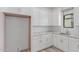 Modern white kitchen with herringbone backsplash and stainless steel sink at 24614 S 183Rd Pl, Gilbert, AZ 85298