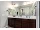 Modern bathroom with double vanity and large mirror at 17657 W Buckhorn Trl, Surprise, AZ 85387