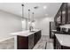 Modern kitchen with stainless steel appliances and a large island with seating at 17657 W Buckhorn Trl, Surprise, AZ 85387