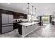 Open concept kitchen with island, stainless steel appliances, and a view into the dining room at 17657 W Buckhorn Trl, Surprise, AZ 85387