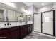 Elegant bathroom featuring a double vanity and glass shower at 17657 W Buckhorn Trl, Surprise, AZ 85387