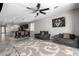 Open concept living room and kitchen with tile floors and modern design at 17657 W Buckhorn Trl, Surprise, AZ 85387